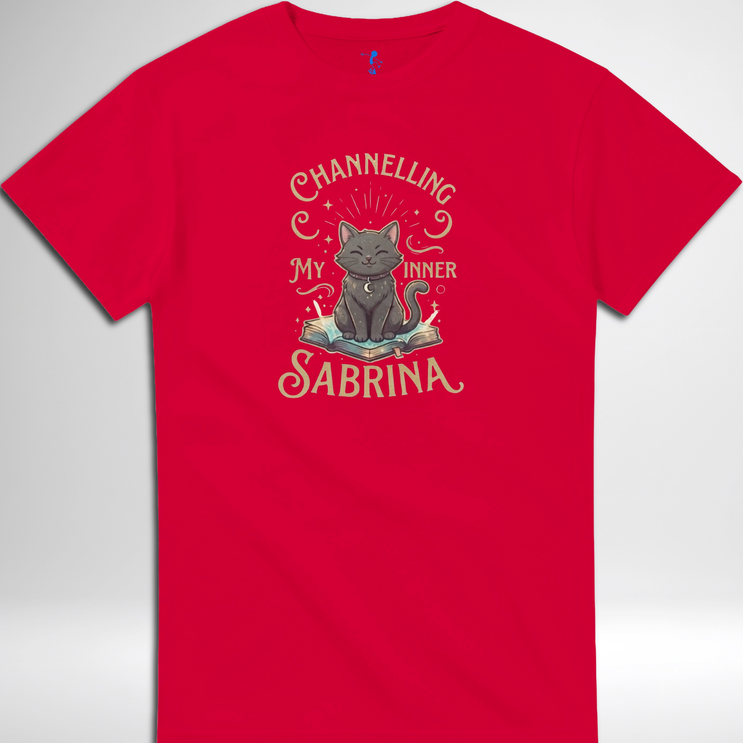 Channelling My Inner Sabrina Halloween t-shirt featuring a magical cat design laid out flat available in red pink, blue, orange, green, black