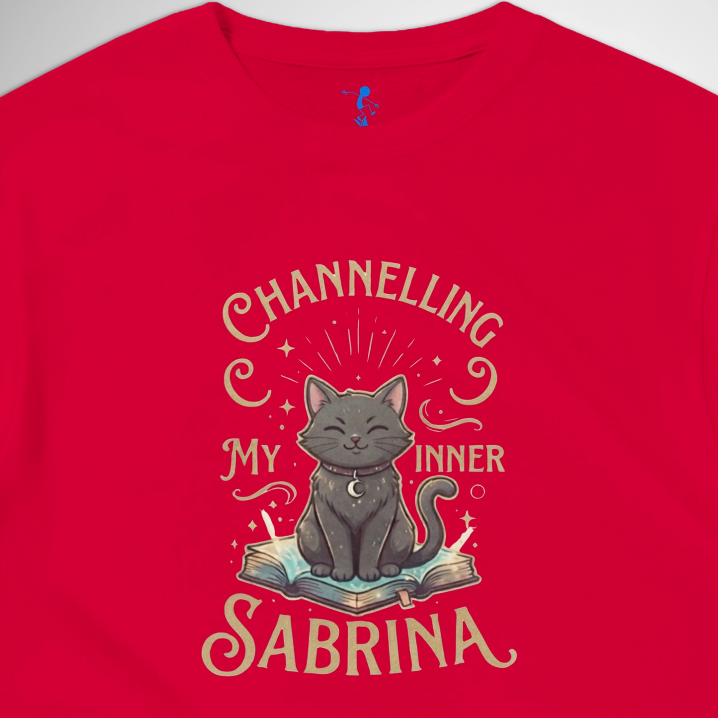 Channelling My Inner Sabrina Halloween t-shirt featuring a magical cat design laid out flat available in red pink, blue, orange, green, black