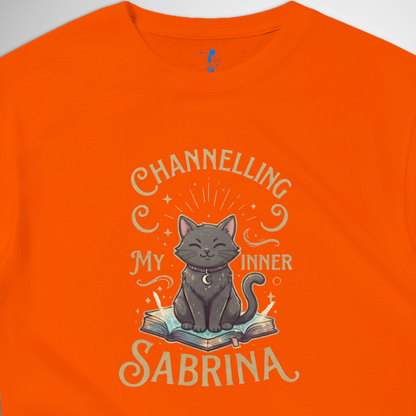 Channelling My Inner Sabrina Halloween t-shirt featuring a magical cat design laid out flat available in red pink, blue, orange, green, black