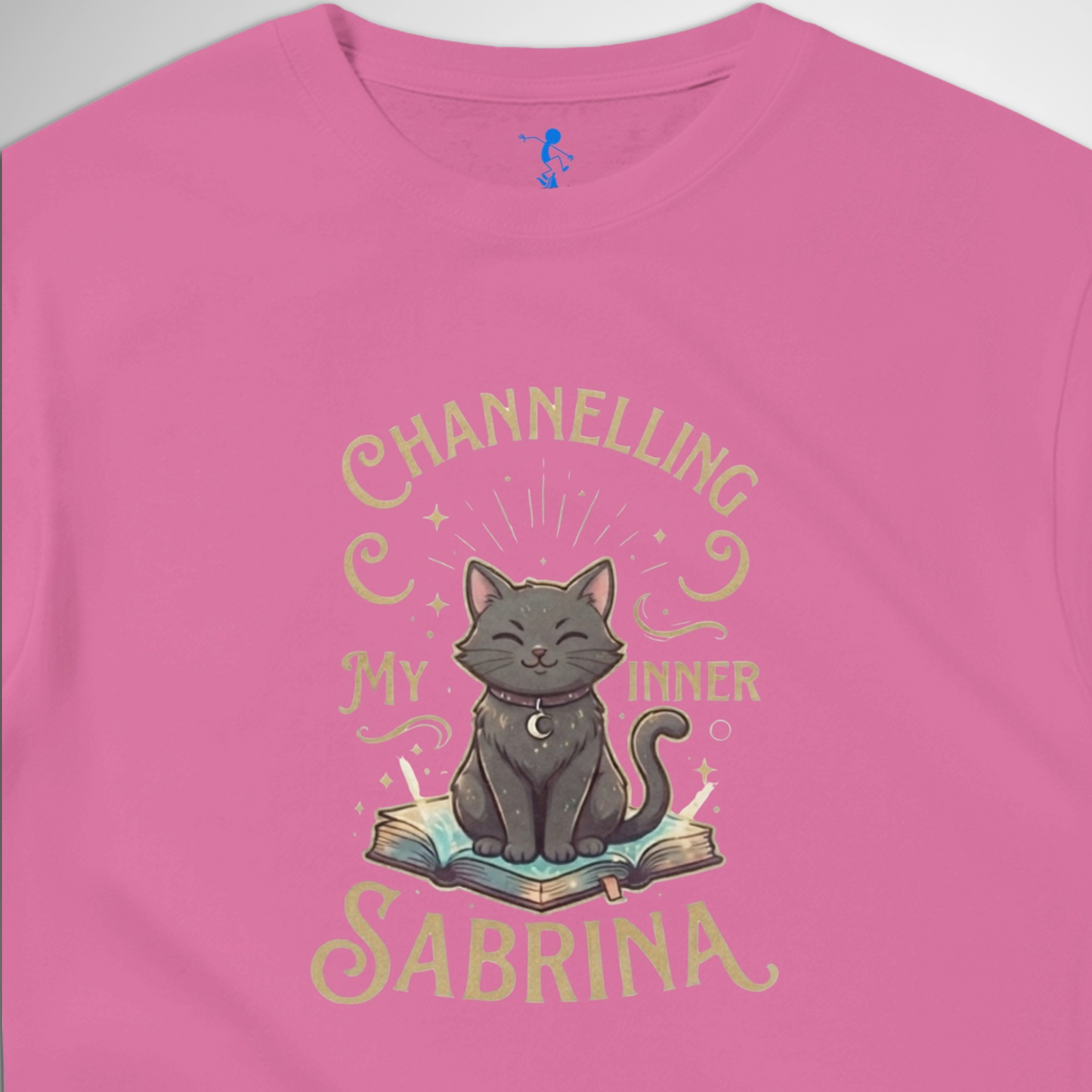 Channelling My Inner Sabrina Halloween t-shirt featuring a magical cat design laid out flat available in red pink, blue, orange, green, black
