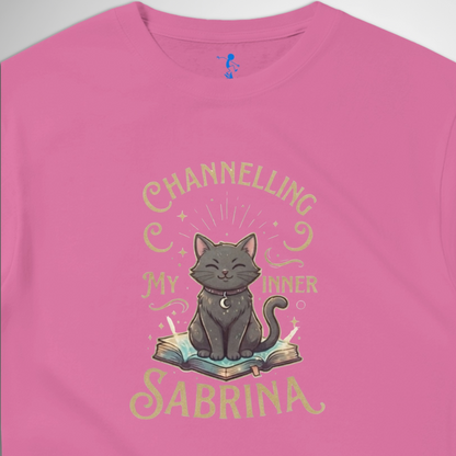 Channelling My Inner Sabrina Halloween t-shirt featuring a magical cat design laid out flat available in red pink, blue, orange, green, black