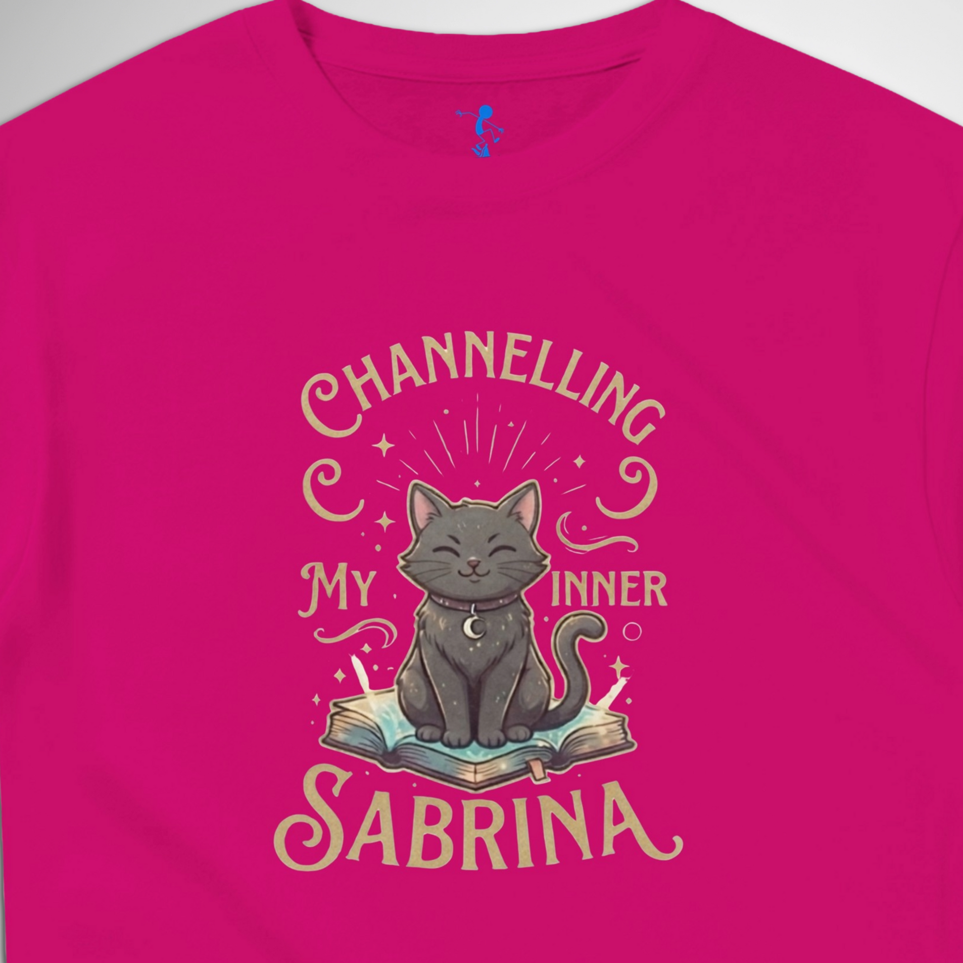Channelling My Inner Sabrina Halloween t-shirt featuring a magical cat design laid out flat available in red pink, blue, orange, green, black