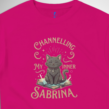 Channelling My Inner Sabrina Halloween t-shirt featuring a magical cat design laid out flat available in red pink, blue, orange, green, black