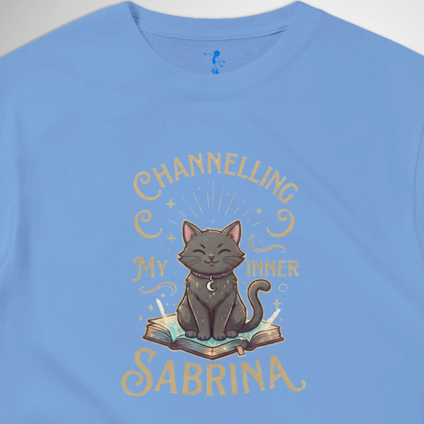 Channelling My Inner Sabrina Halloween t-shirt featuring a magical cat design laid out flat available in red pink, blue, orange, green, black