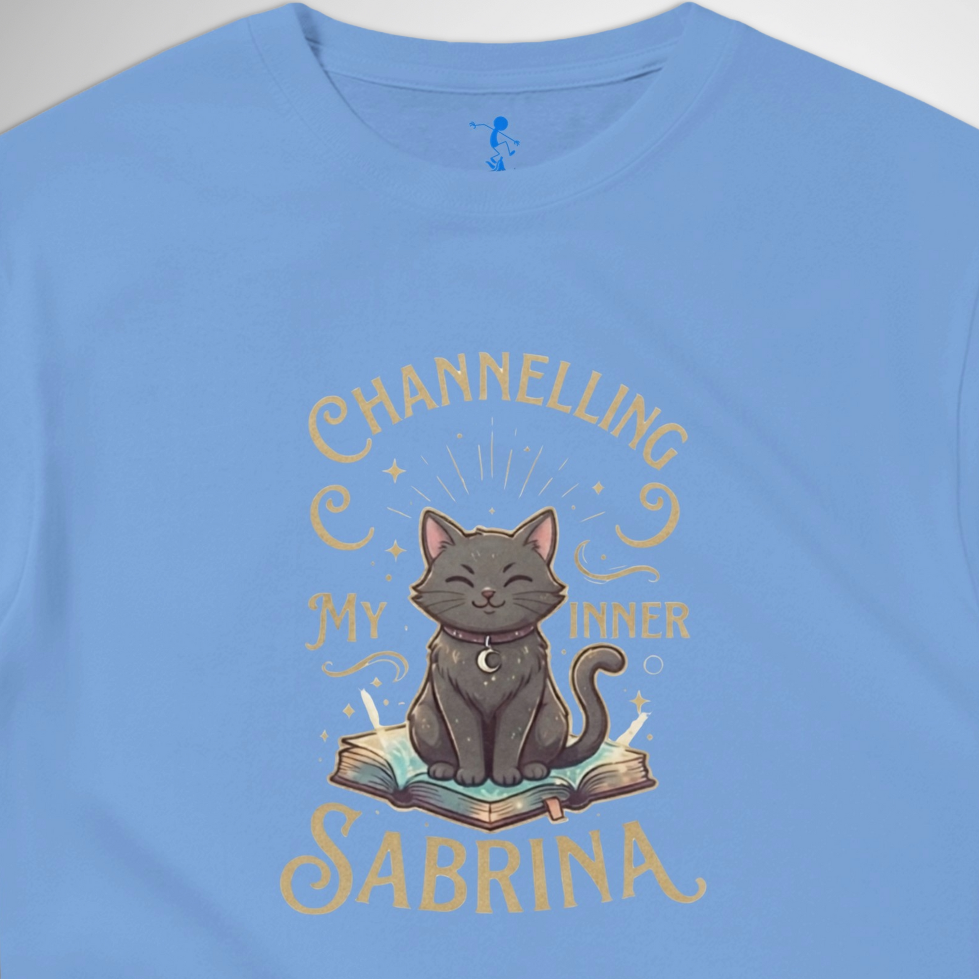 Channelling My Inner Sabrina Halloween t-shirt featuring a magical cat design laid out flat available in red pink, blue, orange, green, black