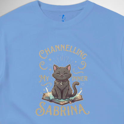 Channelling My Inner Sabrina Halloween t-shirt featuring a magical cat design laid out flat available in red pink, blue, orange, green, black