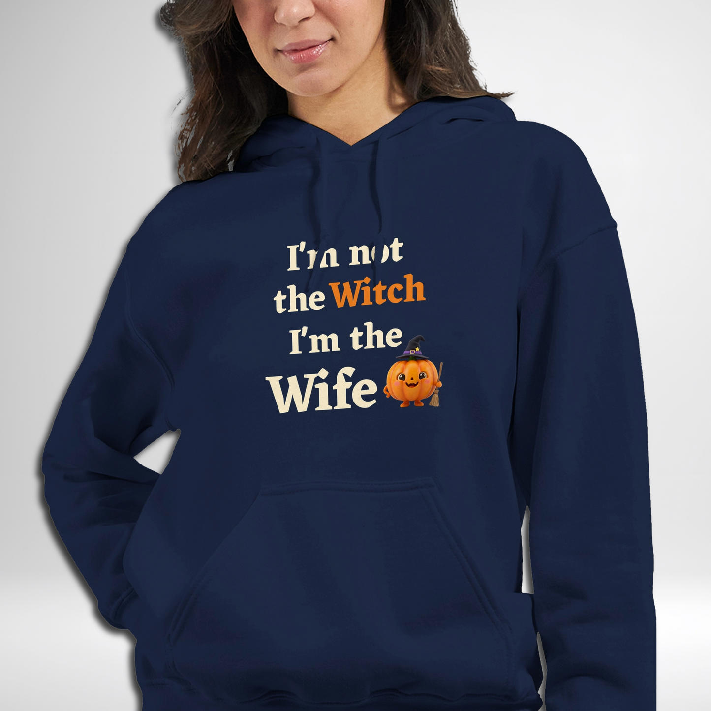 Model wearing women's I'm Not The Witch I'm The Wife Halloween hoodie available in green, black, navy, maroon, grey